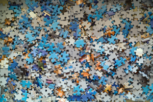A jumble of jigsaw puzzle pieces. Managing technical debt can be like solving a puzzle.
