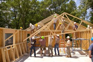 U.S. Army soldiers, along with volunteers from the community, install roof trusses for a Habitat for Humanity home in Brainerd, Minn., July 13, 2010