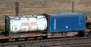 Two shipping containers resting on a “spine car”