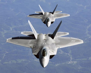 Two pilots line up their F/A-22 Raptor behind a tanker