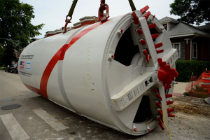 Part of the cutting head of an 84-inch (2.13 m) tunnel boring machine. An obsolete sewer line is out of sight to nearly everyone. Invisibility can raise the question, Where is the technical debt?